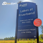 Entrance sign for a residential community, advertising ranches and townhomes for sale.