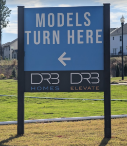 Sign indicating the direction to model homes in a new home community.